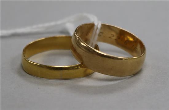 A 22ct gold wedding band and an 18ct gold wedding band (2)